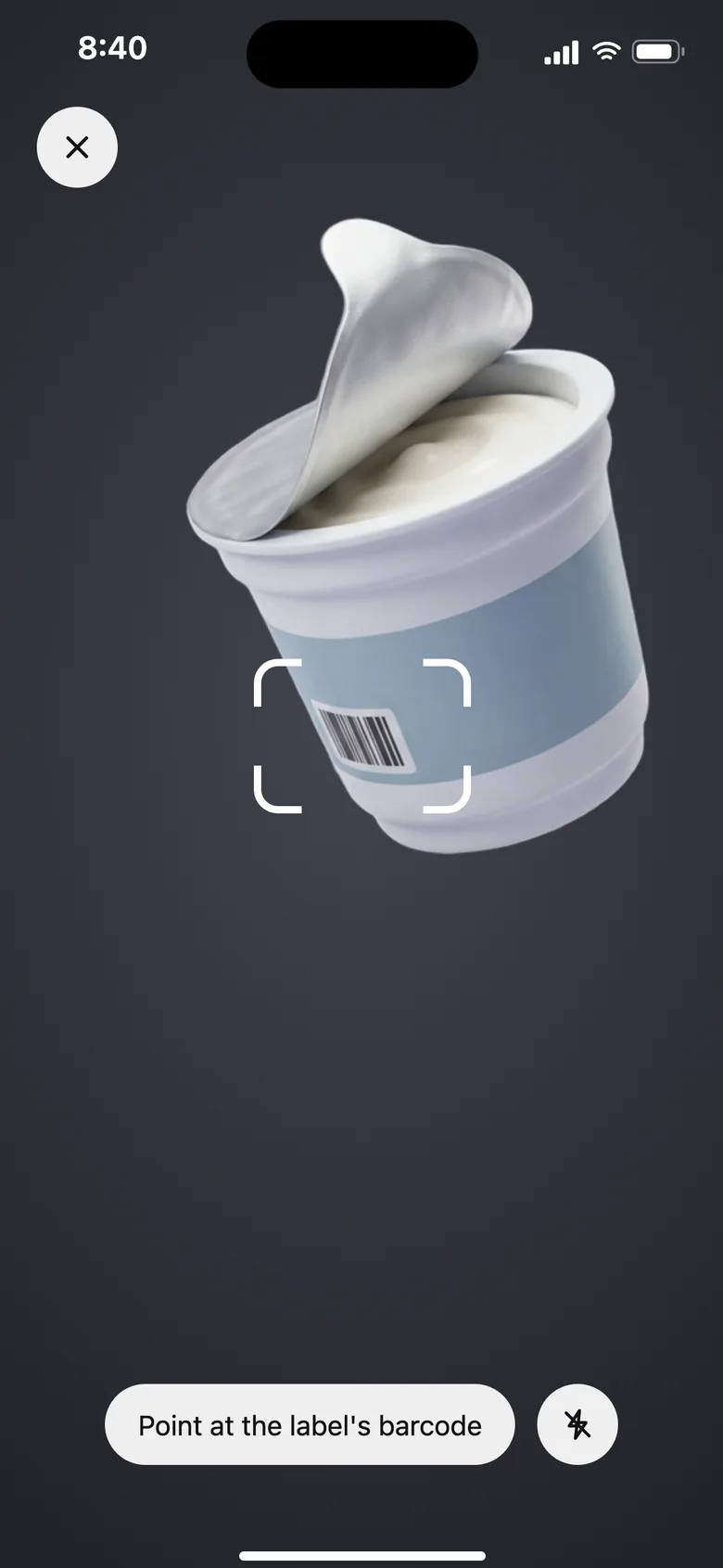 Barcode scanner pointed at a yogurt pot